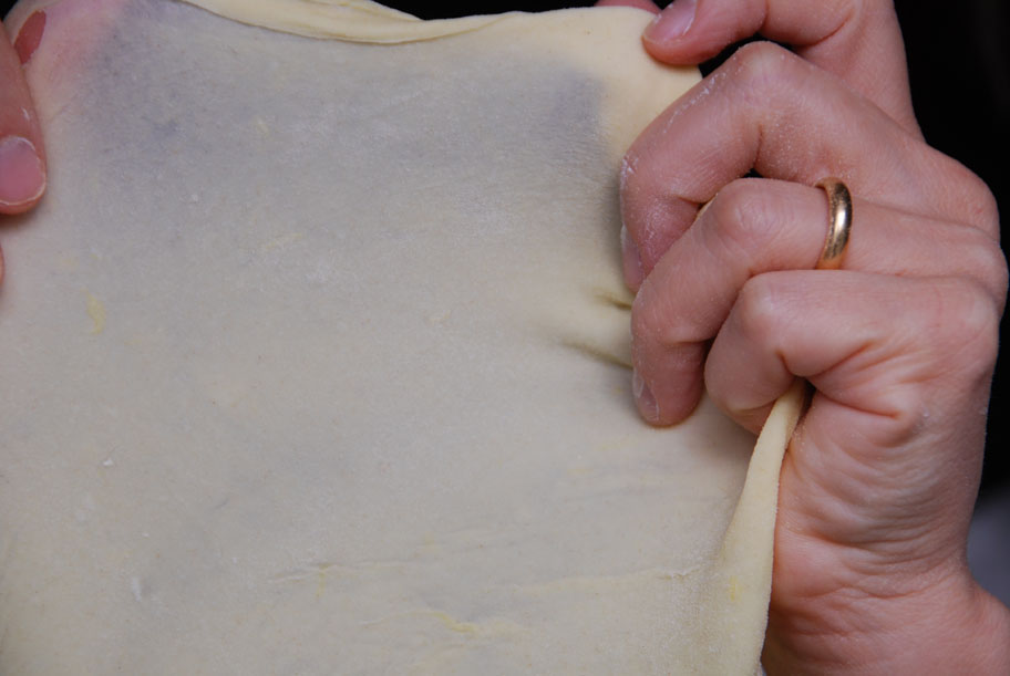 stretching bunuelos dough